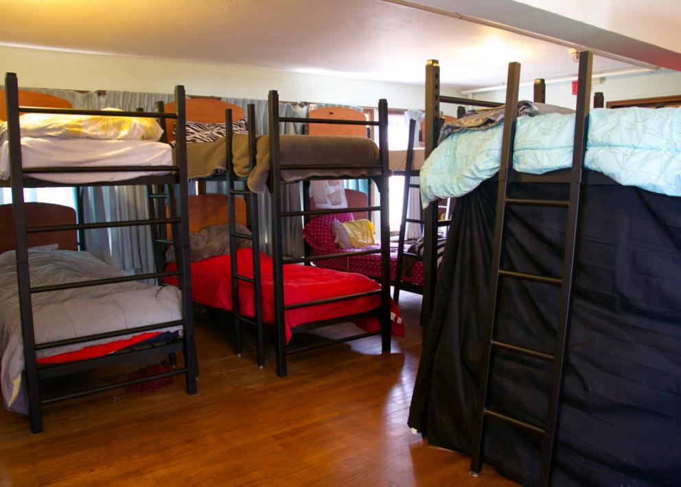 a view of many bunked beds in the Miller Hall sleeping porch, which is identical to the Watkins Hall sleeping porch