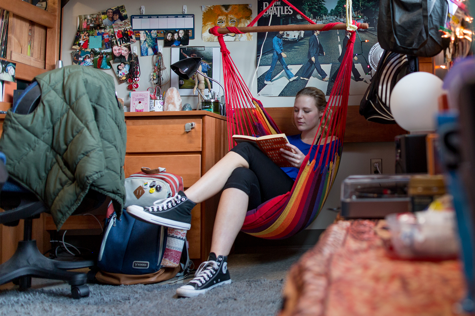 a student reading in a hammock in their room