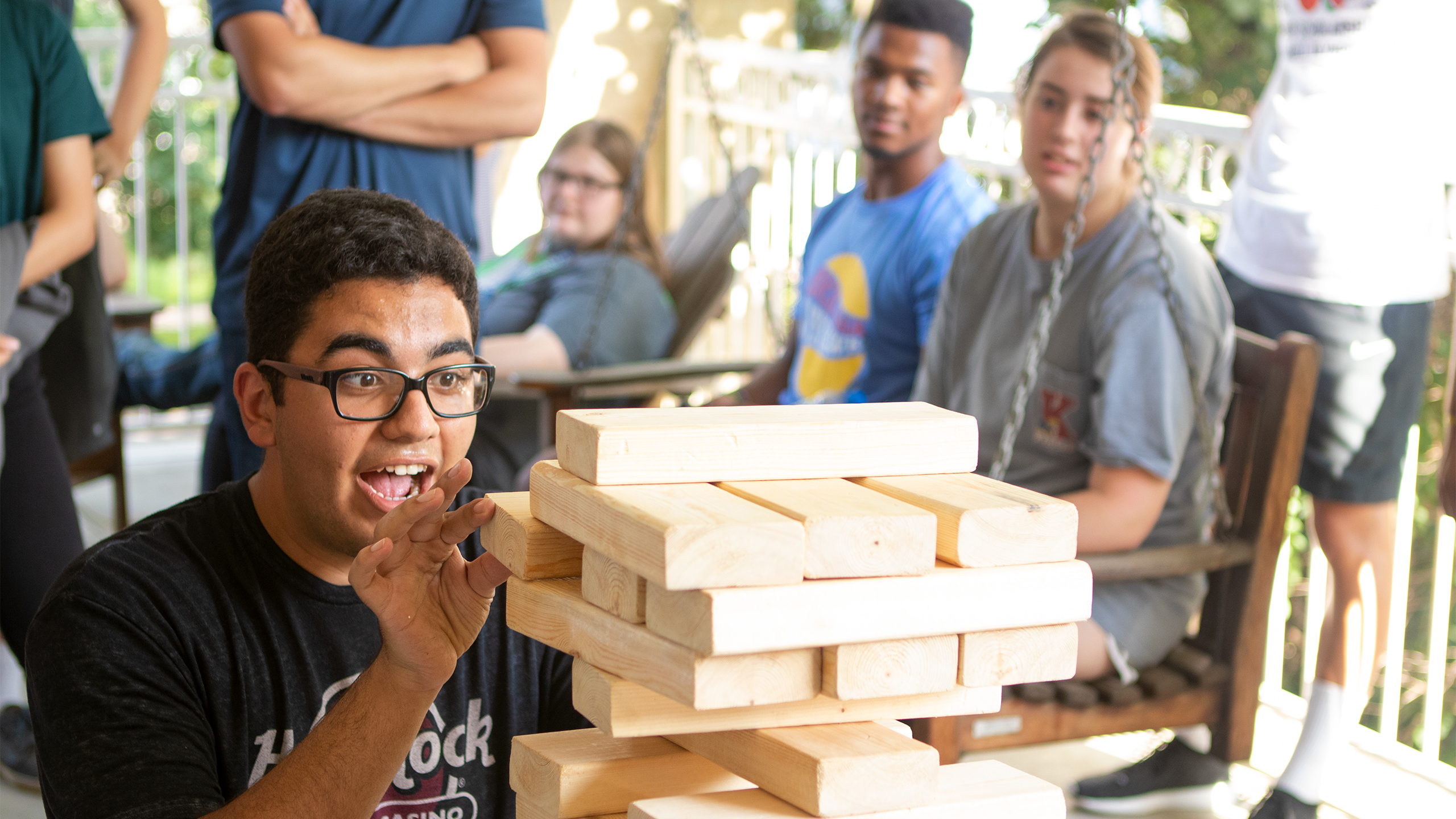 student playing an intense game of Jenga at the Scholarship Hall Olympics