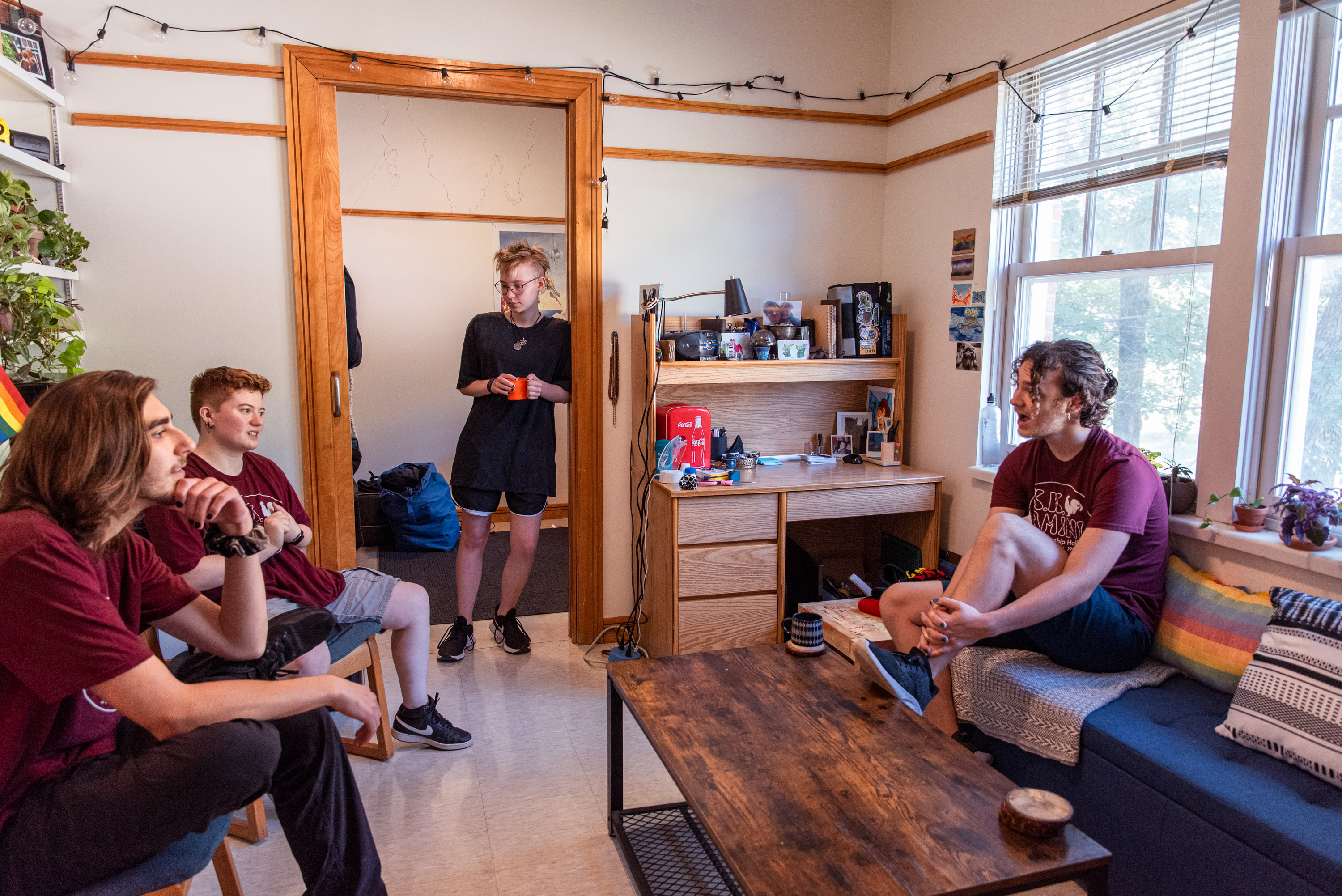 students conversing in their suite living room