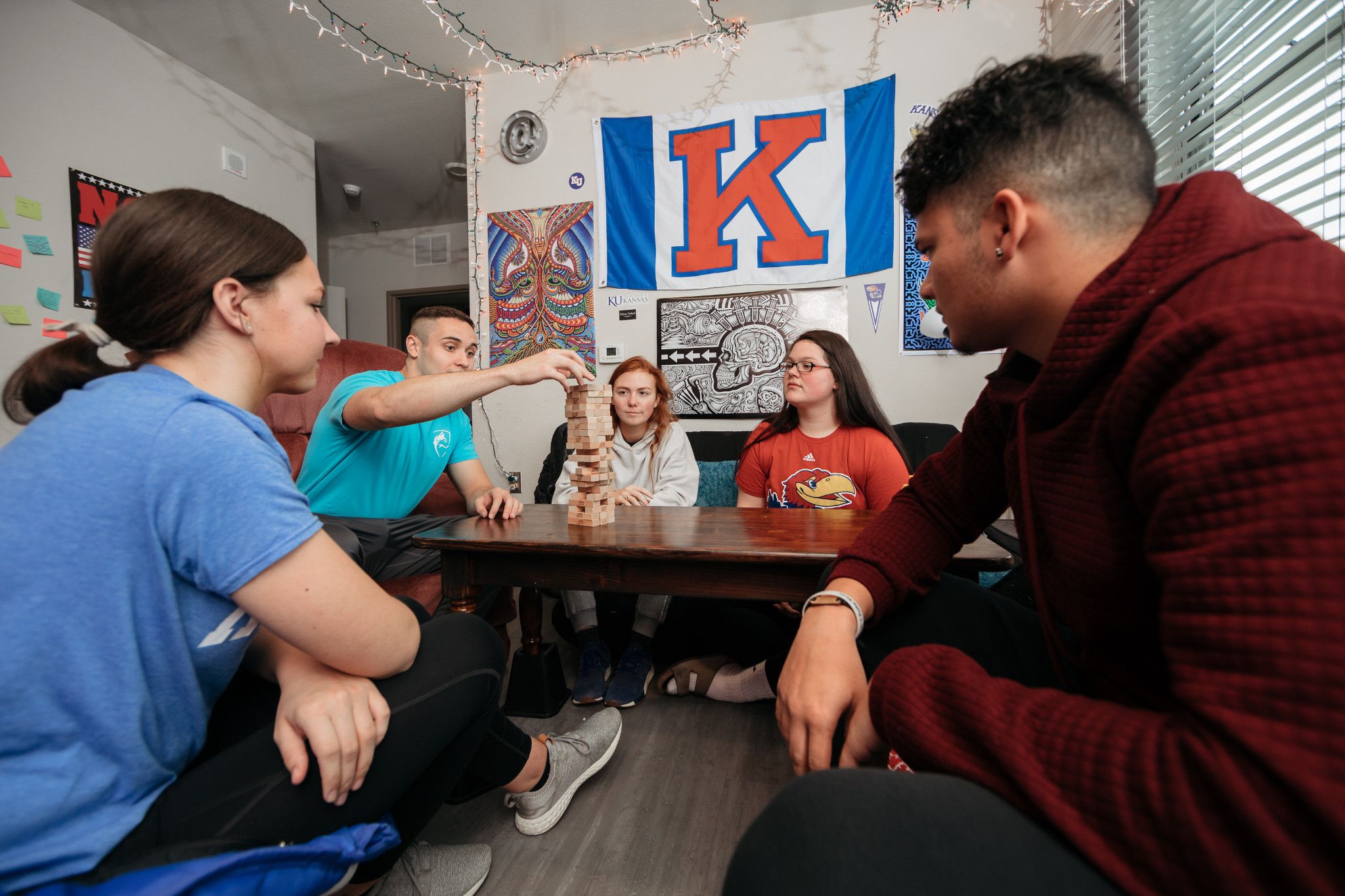 Students playing Jenga in a dorm room 