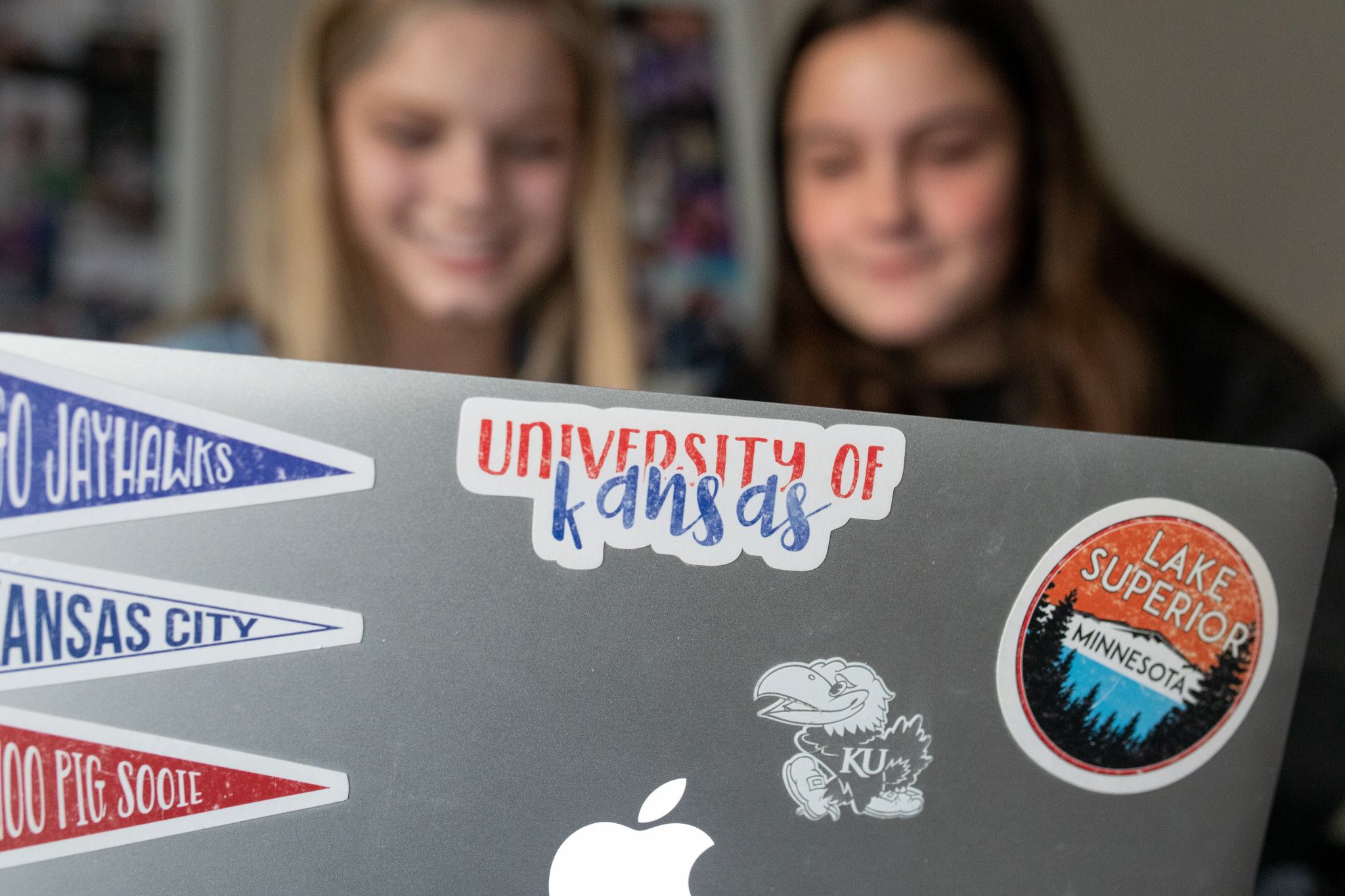 Two students looking at a laptop