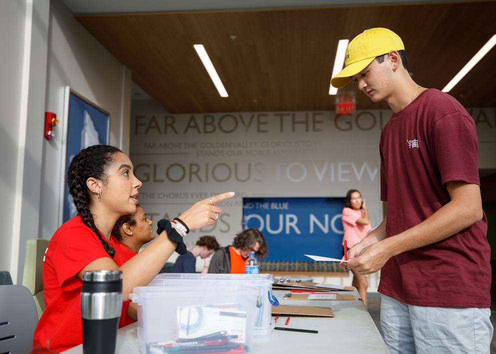 a student employee helping check-in a new resident on move-in day