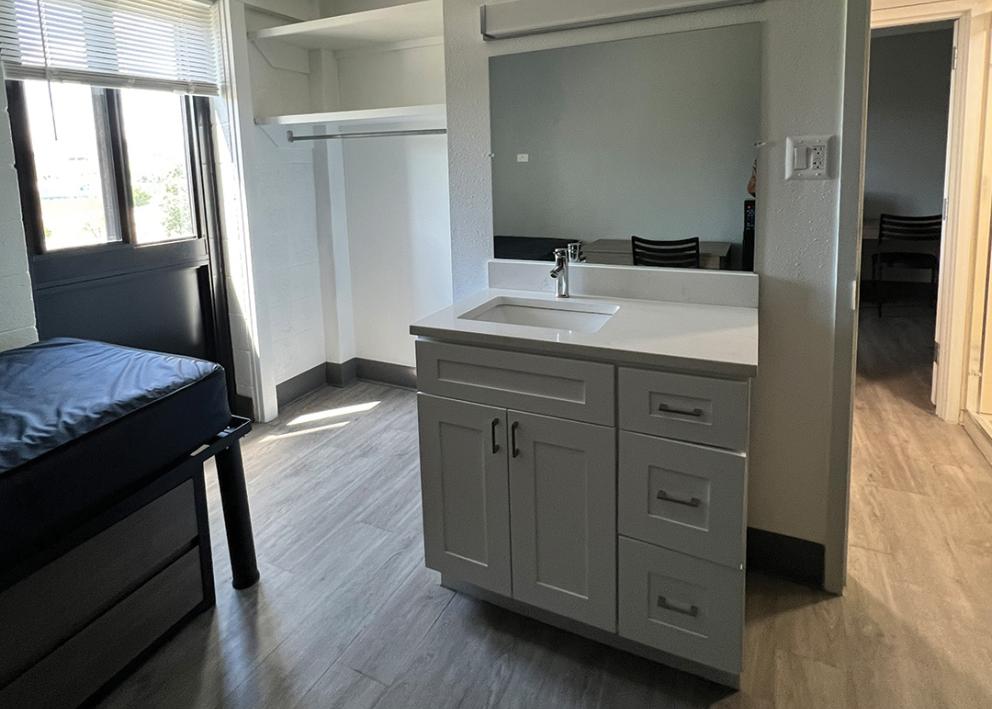 Image of a sink and bed in a Naismith 4-person split suite