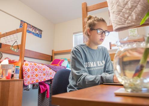 Resident enjoys quiet study time in her suite