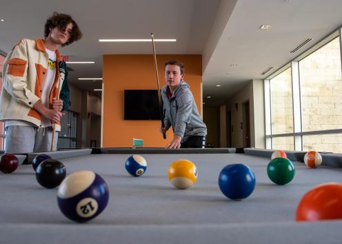 two young men playing pool in the Daisy Hill Commons