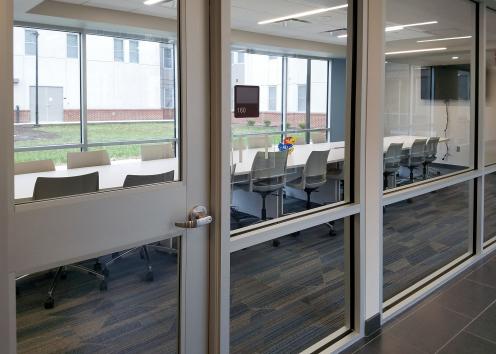 exterior view through glass window wall of long conference room